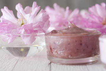 Obraz na płótnie Canvas Cosmetic creams with japanese cherry flowers