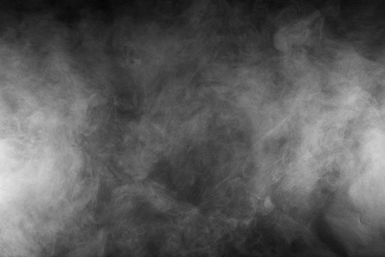 White smoke texture on a black background. Halloween texture and abstract art