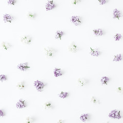 Flowers composition. Spring lilac flowers on white wooden background. Flat lay, top view, square