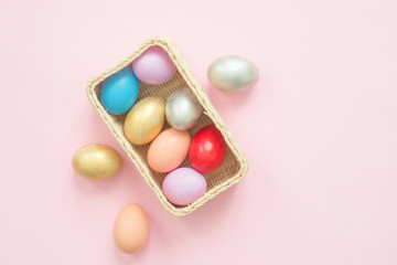 Flat lay top view colorful easter egg painted in pastel colors composition on pink pastel color background. Easter day background top view with copy space.