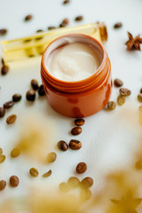 Obraz na płótnie Canvas Jar of caffeine cream and coffee beans on white background, top view