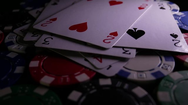 Poker cards fall down on poker chips