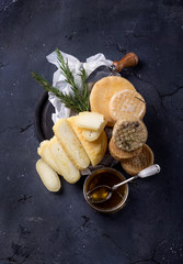 Traditional Portugese semi-soft cheeses from evora alentejo region served with fresh rosemary and honey.
