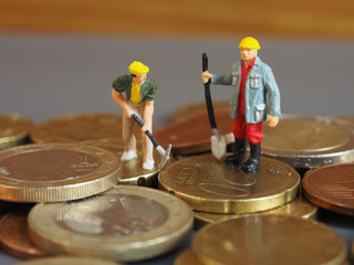 Fototapeta premium Miniature worker people stand on Euro coins. Business and idea concept.