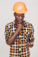 African-American builder uses measuring tape