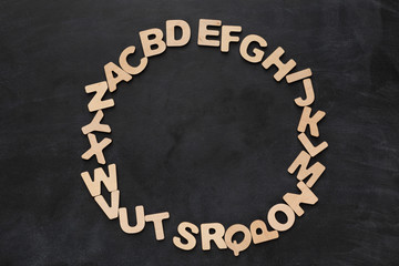 Fototapeta na wymiar Wooden english letters on black background