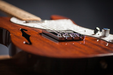 Fototapeta premium Close up of vintage electric guitar. Musical instrument for jazz , rock and blues styles. Black background