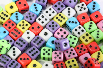 many colored gaming dice with black dots