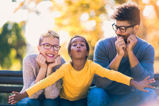 Happy Young Mixed Race Couple Spending Time With Their Daughter Having Fun