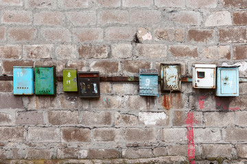 old mailboxes on an old dirty wall