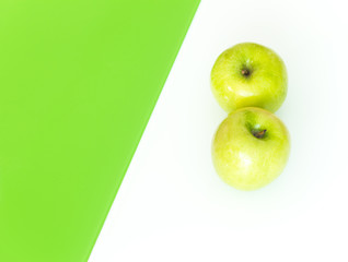 Green apple on the white-green glass background.