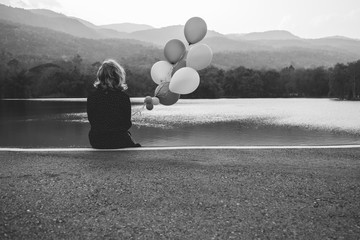 a women sitting alone on the road waiting for love, alone concept