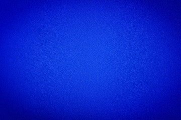 Texture of  bumpy, rugged  metal painted blue with vignette