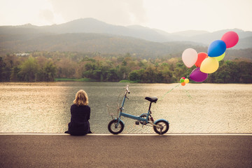 a women sitting alone on the road waiting for love, alone concept