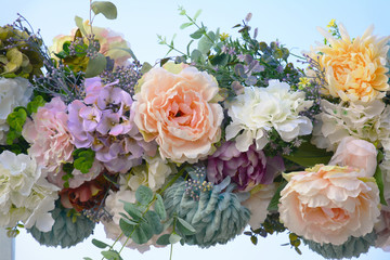 Fototapety  Decorative garland of artificial flowers - roses, hydrangeas and chrysanthemums.