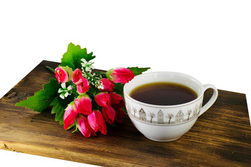 Cup of tea and yellow tulips on a wooden background. A bouquet of yellow tulips and a cup of coffee.
