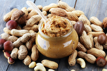 Creamy peanut butter on wood table. Selective focus.