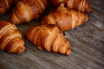 The freshly baked croissants  on wooden background