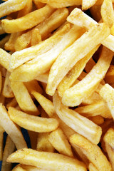 Tasty french fries on blue table background