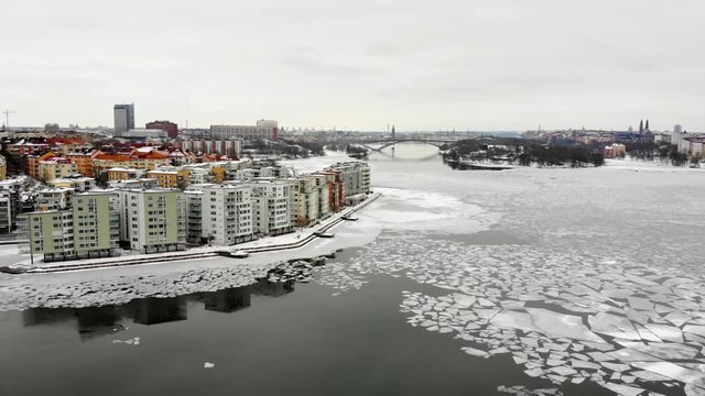 Aerial view of Stockholm on a wintry day.  Apartment buildings of "Lilla Essingen" in the foreground. Side panning.