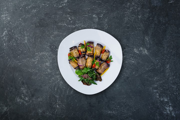 Eggplant rolls with tomatoes and garlic.