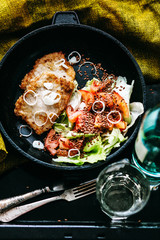 steak - roast chicken with tomato and lettuce on a white dish