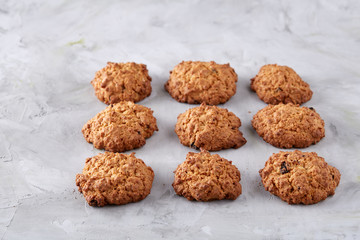 Sweet biscuits arranged in pattern on light textured background, close-up, shallow depth of field, selective focus.