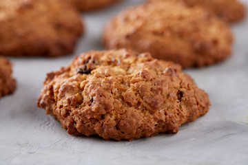 Sweet biscuits arranged in pattern on light textured background, close-up, shallow depth of field, selective focus.
