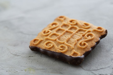 Square biscuits arranged in pattern on light textured background, close-up, shallow depth of field, selective focus.