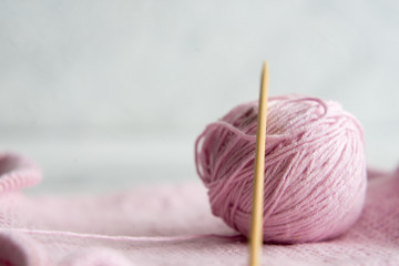 Fototapeta na wymiar knitted pink tangle on wooden background