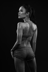 Naklejka premium Sporty young girl in sportswear exercising black and white