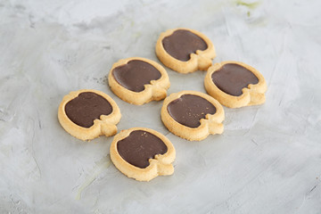 Apple shaped biscuits arranged in rows on light textured background, close-up, shallow depth of field, selective focus.