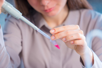 Young woman cutting of sample from pcr microtube rack