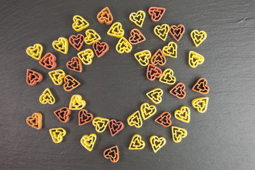 raw pasta noodles in the shape of hearts