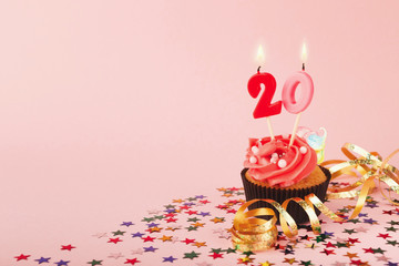 20th birthday cupcake with candle and sprinkles