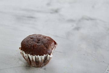 Tasty muffins arranged in pattern on light textured background, close-up, shallow depth of field, selective focus.