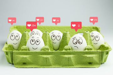 Happy eggs with many likes, one sad egg without likes. Social networks