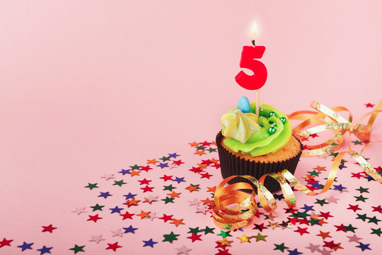 Fifth birthday cupcake with candle and sprinkles