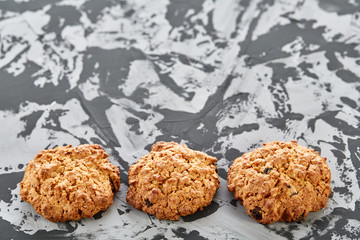 Sweet cookies arranged in pattern on light textured background, close-up, shallow depth of field, selective focus.