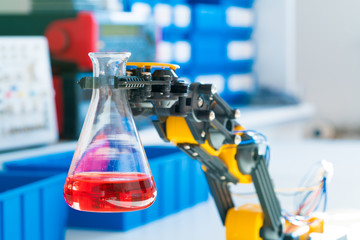 the robot holds the tube with the chemical