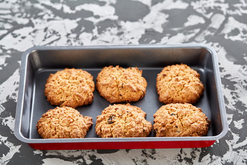 Fresh baked biscuits on a cookie sheet, top view, close-up, selective focus, shallow depth of field.