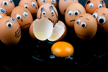 Fun concept: raw eggs with googly eyes and drawn features are in shock and sad as they witness...
