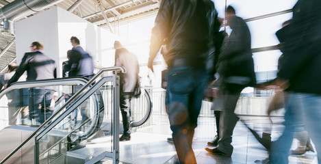 anonymous crowd of blurred people rushing on escalators