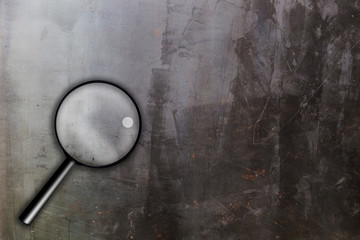 magnifying glass on black chackboard texture background