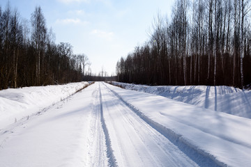 Obraz premium snowy winter road covered in deep snow