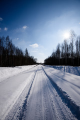 Obraz premium snowy winter road covered in deep snow