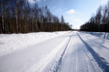 Fototapeta na wymiar snowy winter road covered in deep snow