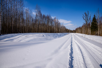 Fototapeta na wymiar snowy winter road covered in deep snow