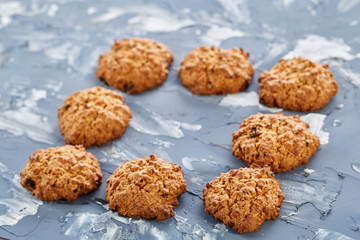Sweet cookies arranged in pattern on light textured background, close-up, shallow depth of field, selective focus.