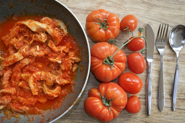 tripe in pan with tomato sauce